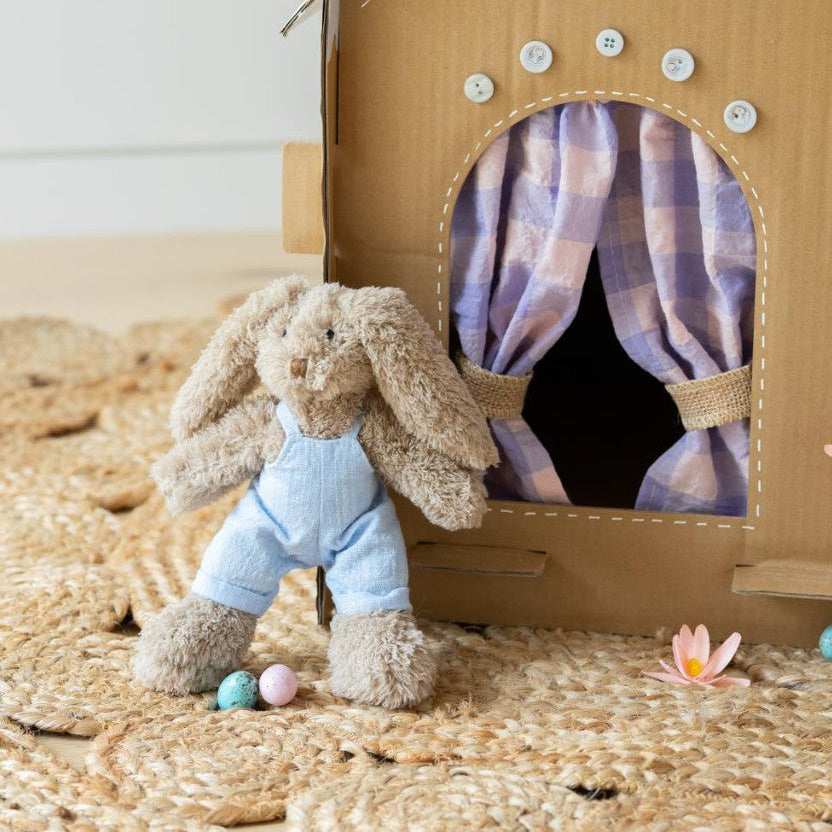 Baby boy honey bunny dressed in light blue overalls