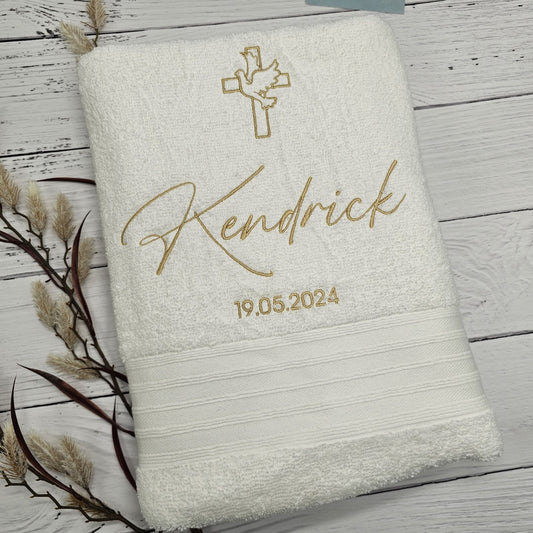Personalized Christening towel with embroidered name and date on a wooden surface