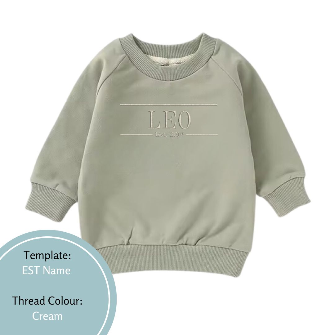 khaki green baby and toddler crewneck jumper embroidered with a name and est date using a cream coloured thread