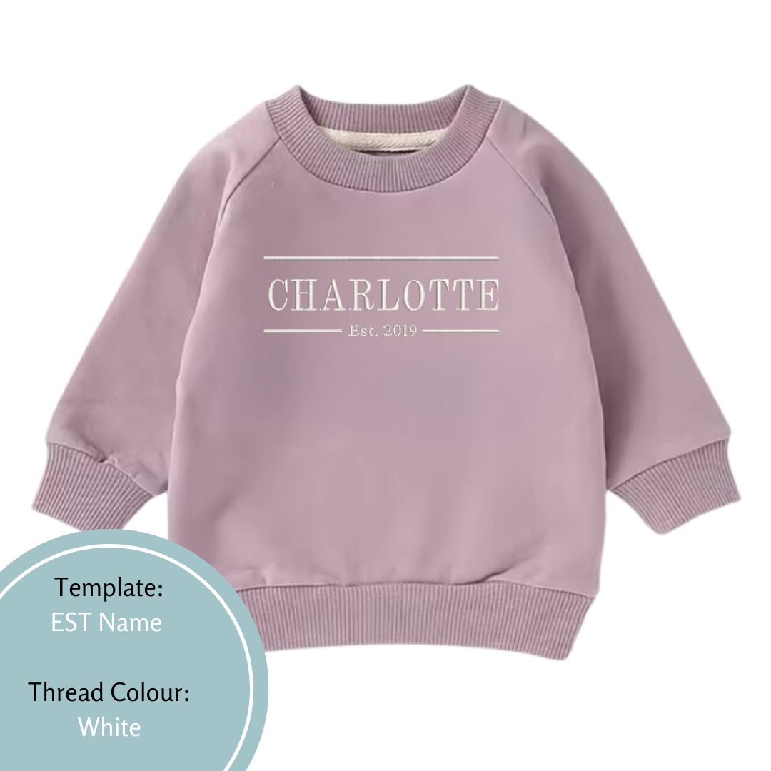 purple baby and toddler crewneck jumper embroidered with a name and est date using a white colour thread
