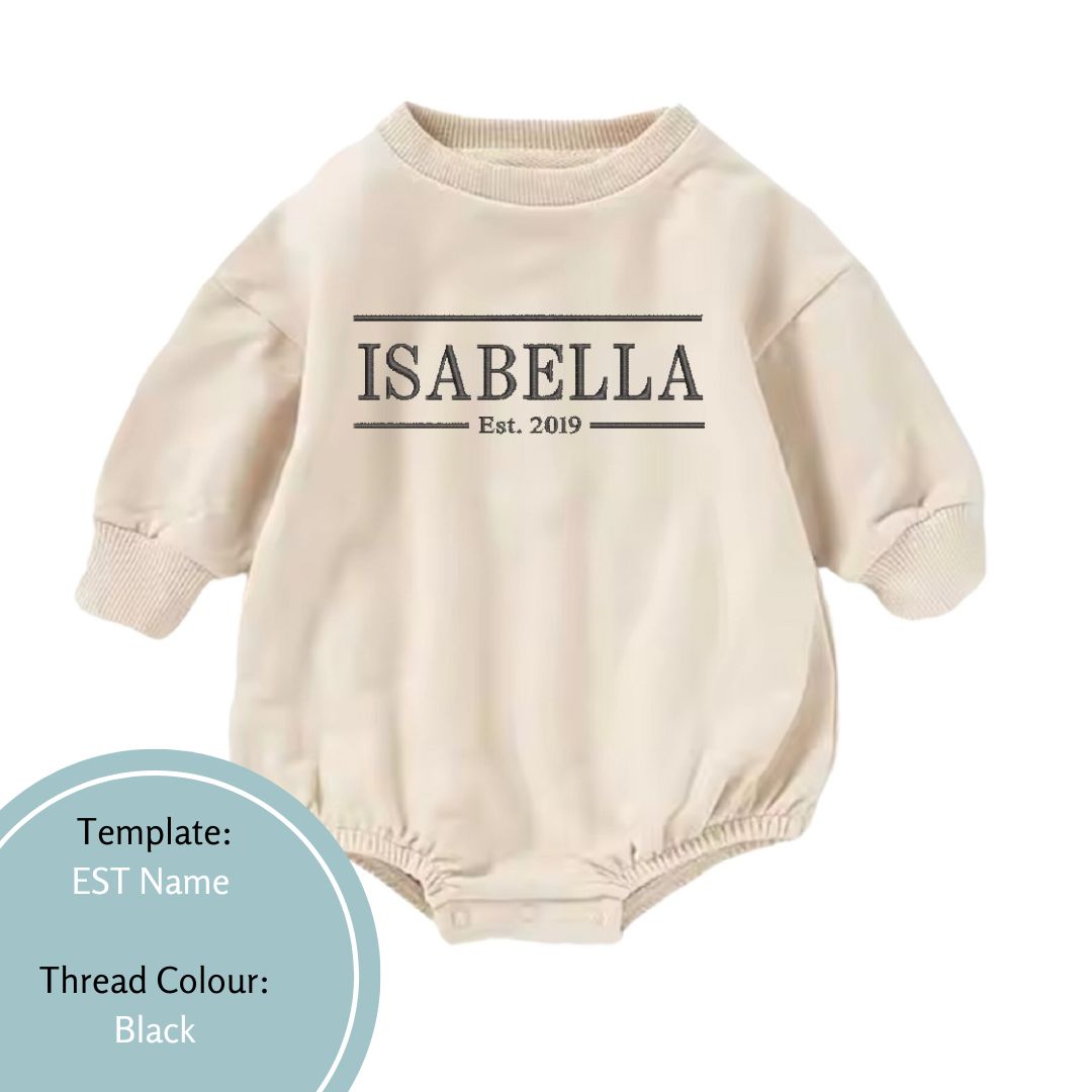 beige bubble romper embroidered with est name in a black thread