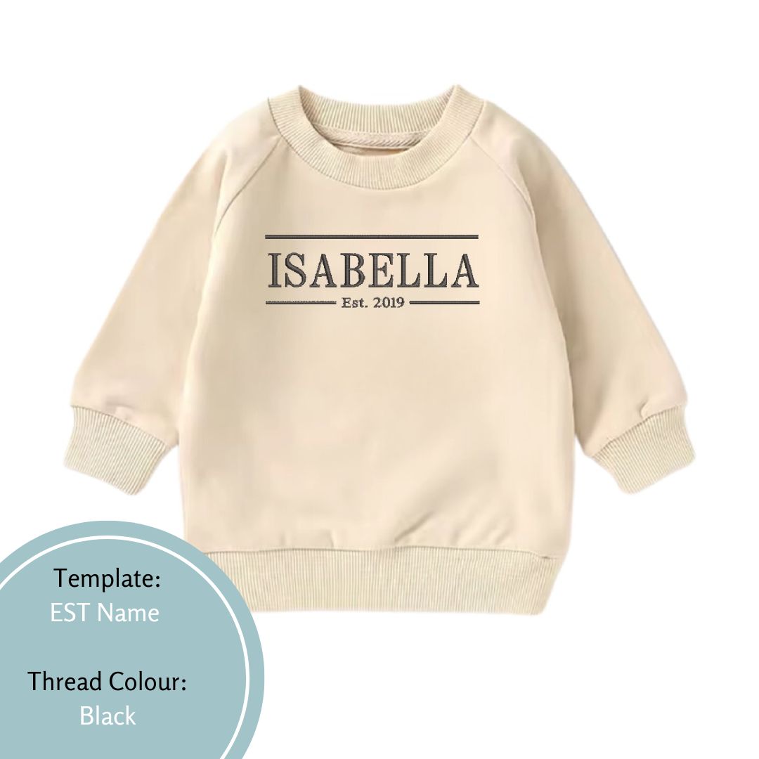 beige baby and toddler crewneck with est date and name embroidered using black thread