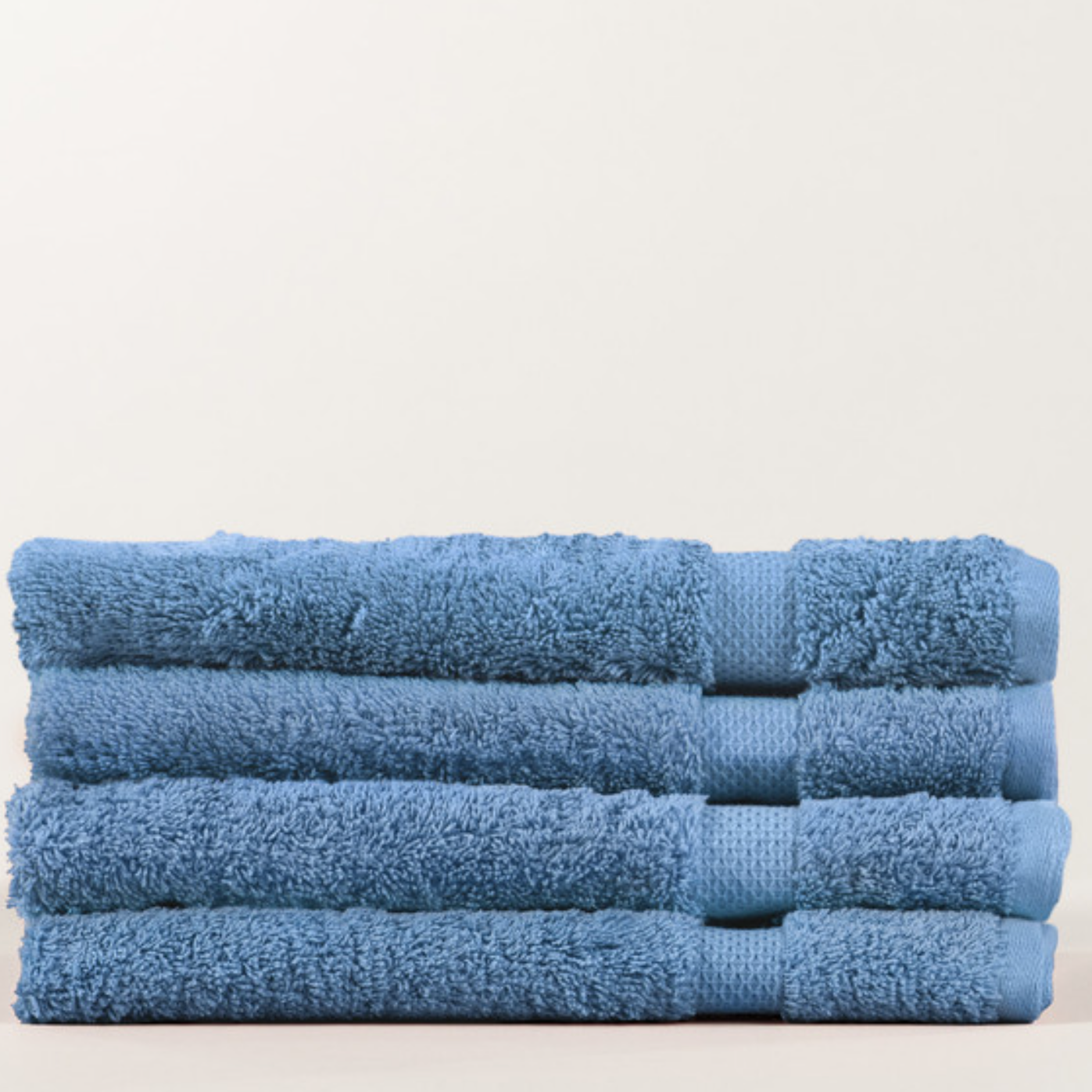 Stack of blue towels on a light background