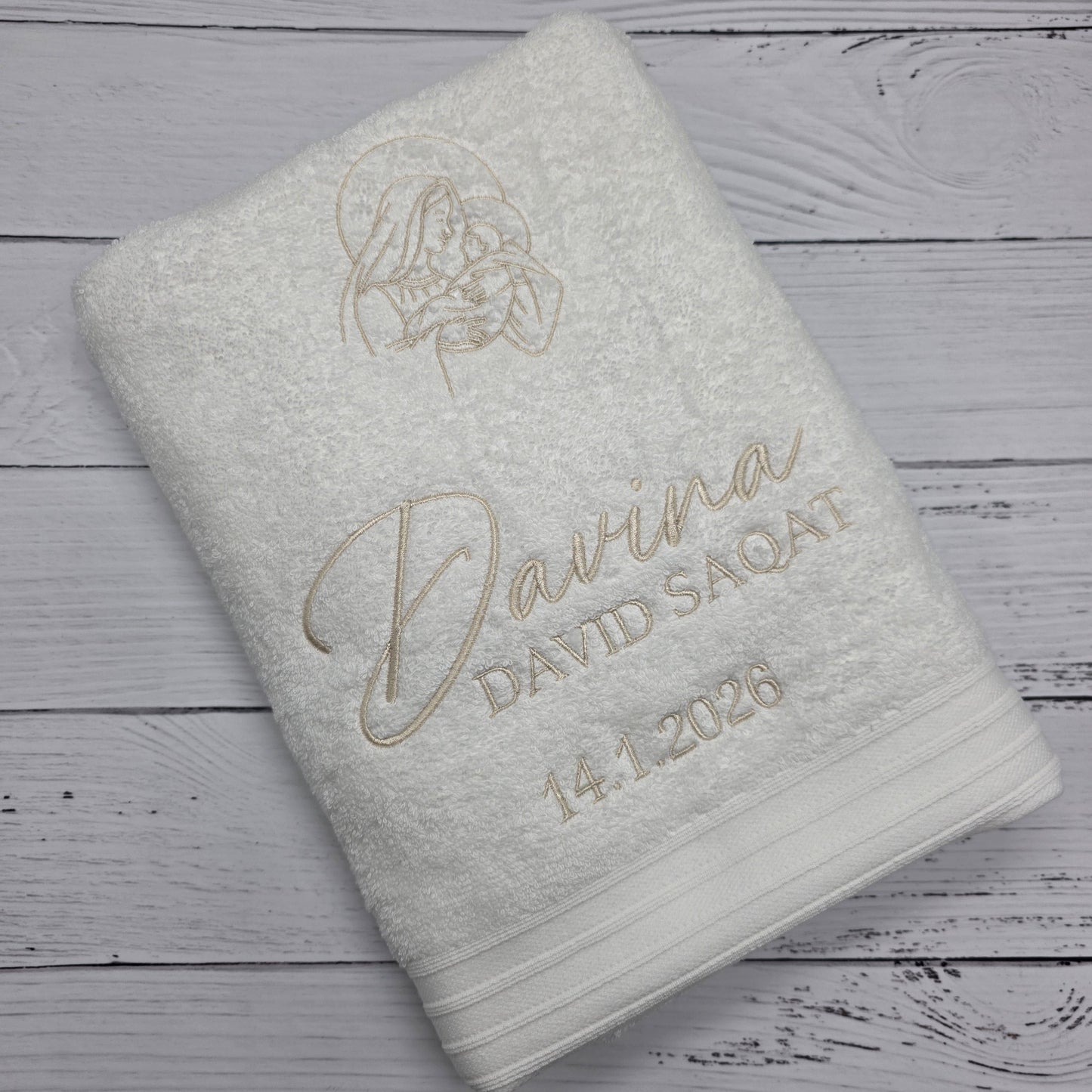 Folded towel with branding on a wooden surface