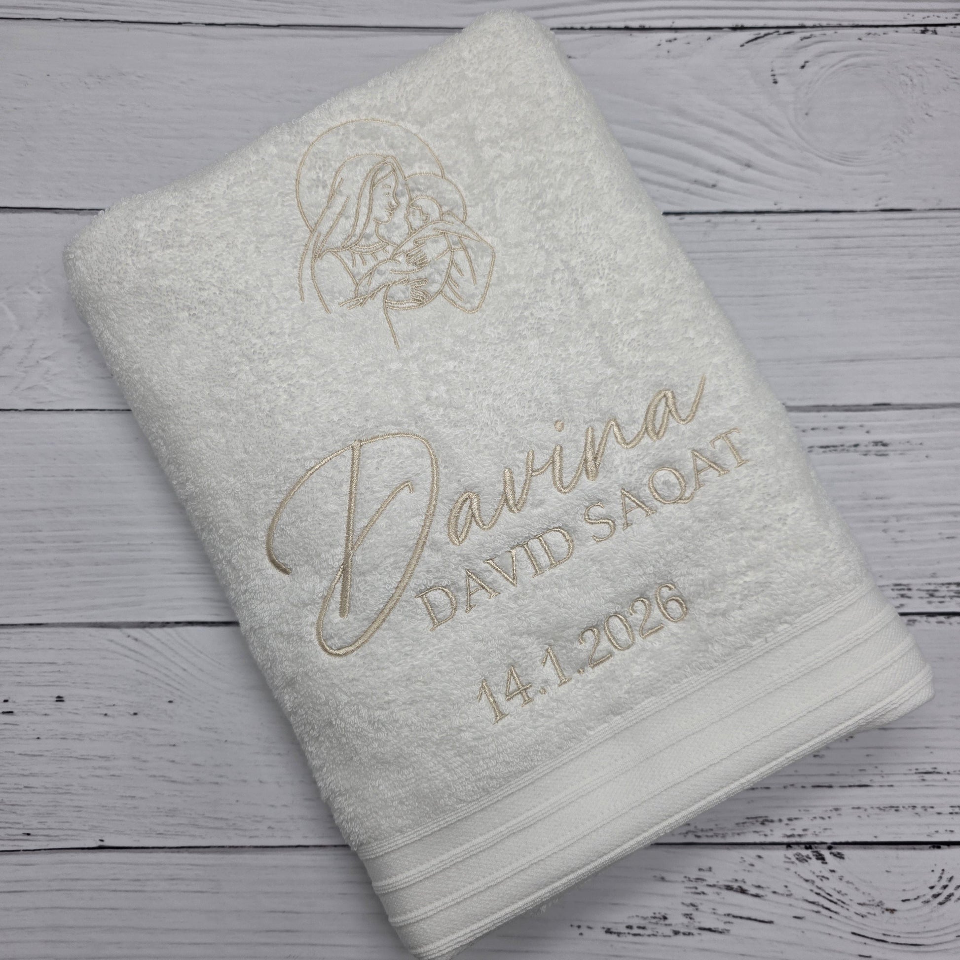 Folded towel with branding on a wooden surface