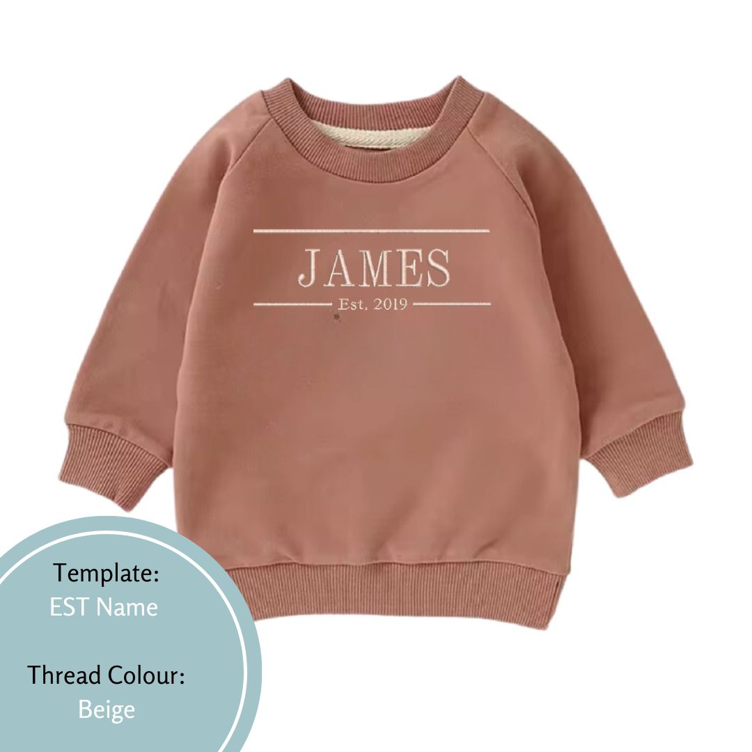 latte brown baby and toddler crewneck jumper embroidered with a name and est date using beige colour thread