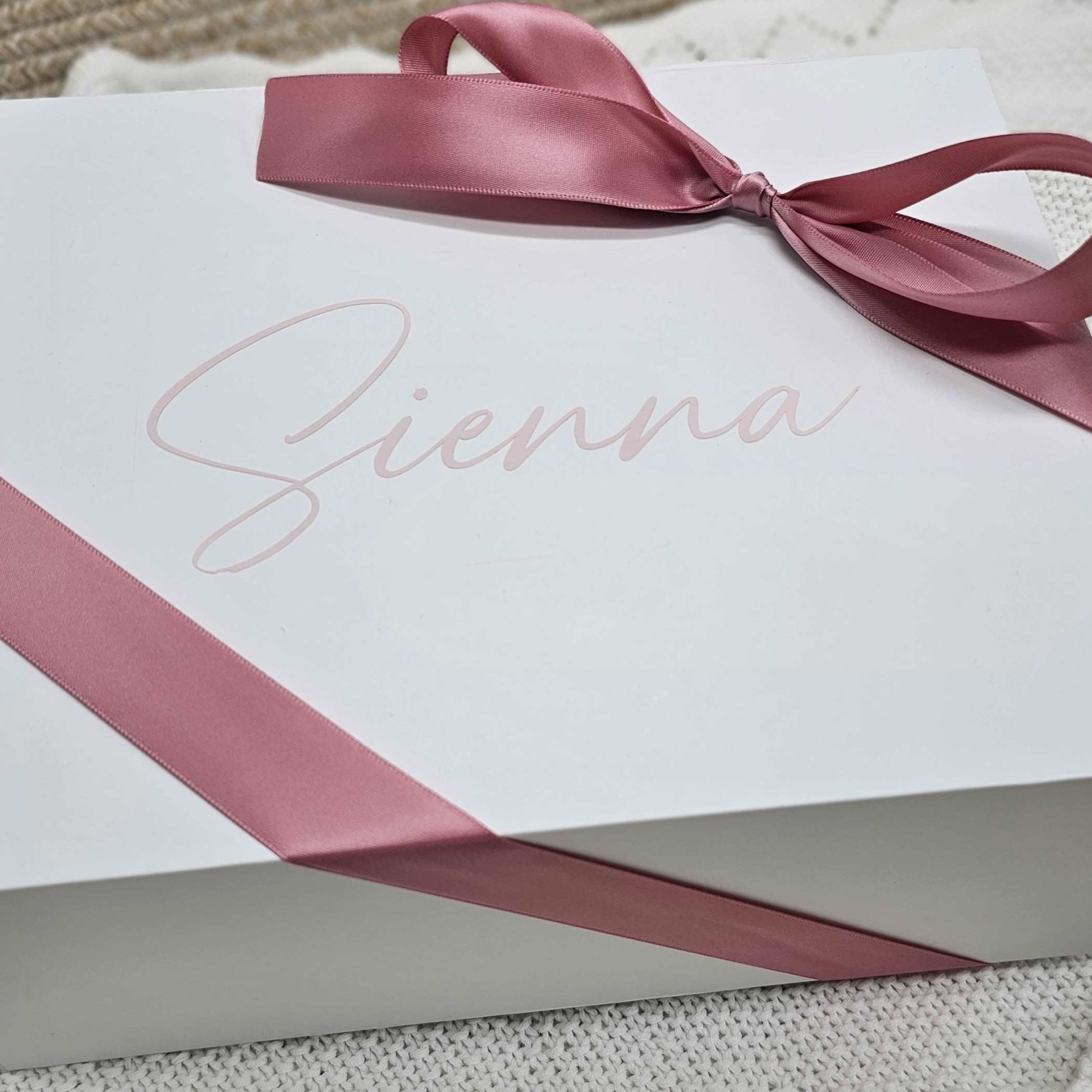 Personalized white gift box with a pink ribbon and the name 'Sienna' printed on the lid.